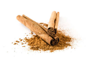 Cinnamon sticks and powder isolated on white background
