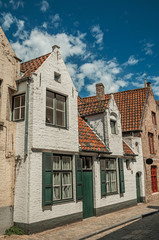 Brick facade of houses in typical style of the Flanders’s region in street of Bruges. With many canals and old buildings, this graceful town is a World Heritage Site of Unesco. Northwestern Belgium.