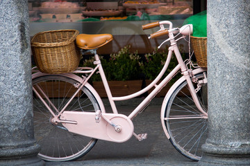Fototapeta na wymiar vintage pink bicycle supported by two columns