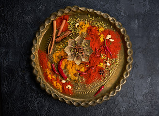 Various spices and spicy in a metal vintage plate, top view