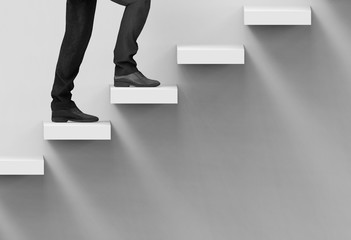 3d Rendering. A business man climbing up on staircase with copy space wall background.
