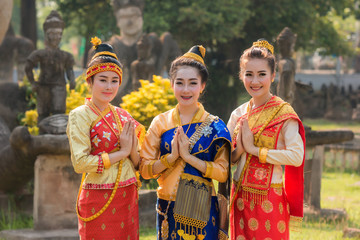Beautiful girl in Laos costume,Asian woman wearing traditional Laos culture at temple.Vintage style. - obrazy, fototapety, plakaty