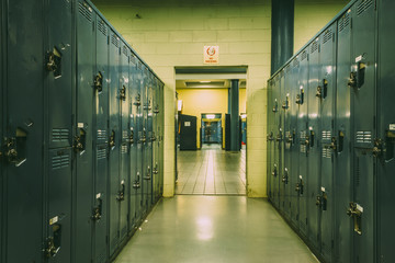 Long corridor full of lockers in a basement