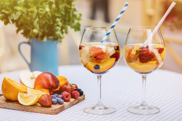 Top view of summer dinks, fruit cocktails on white wood table wi