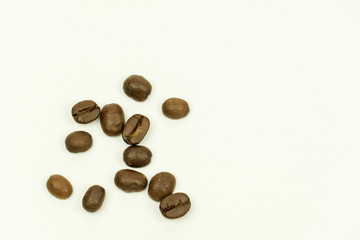 close up of medium or dark roasted coffee beans isolated on white background, can be used as a background or graphic object in your ads.