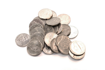 Pile of new and old American coins (Five cents) on a white background.