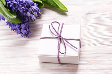 Gift box and Hyacinth flowers on wood backgroubd