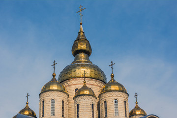 Fototapeta na wymiar Dome of the church on the blue sky background.