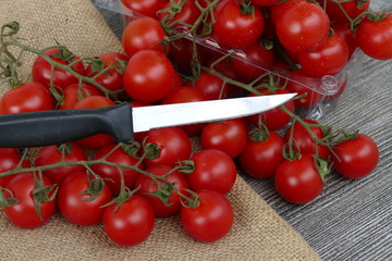 Vine tomatoes and knife on black back ground,

