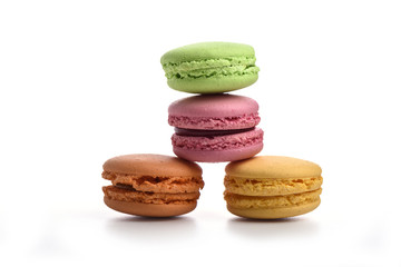 Green, pink, orange and yellow macaroons isolated on white