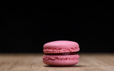 Pink macaroon on wooden background