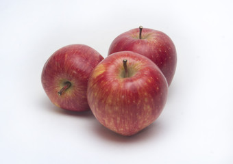 three red apples on a white background