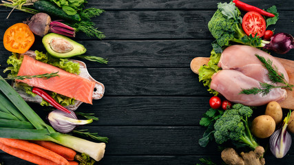 Healthy food. Fish, meat and vegetables. On a dark wooden background. Top view. Copy space.