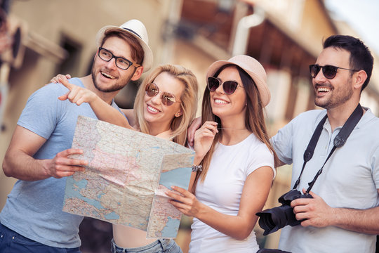 Group of smiling friends with map