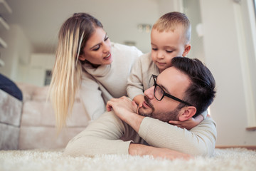 Obraz premium Happy young family having great time at home