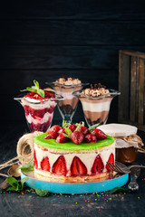 Assortment of Strawberry Desserts. On a wooden background. Top view. Copy space.