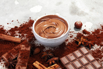 Chocolate bars on table with chocolate powder.