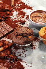 Chocolate muffin and nut muffin, homemade bakery on grey background