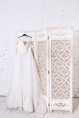 Wedding dress hanging on a beautiful decorative shield