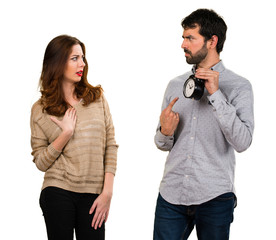 Young couple holding vintage clock