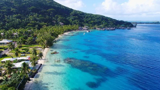 Aerial view of tropical paradise of Bora Bora island, crystal clear water of scenic turquoise blue lagoon - South Pacific Ocean, French Polynesia from above, 4k UHD