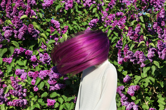 Girl Teenager With Purple Hair On Background Of Lilac Bush