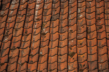 Close-up of orange tiles forming a pattern, in the late afternoon light at Damme. A quiet and charming countryside old village near Bruges. Northwestern Belgium.