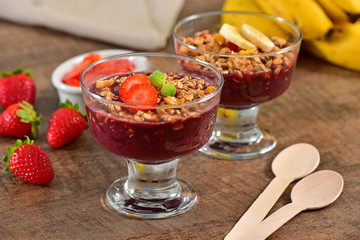 Acai berry cups on wooden background