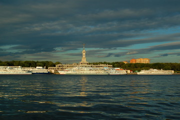 Fototapeta na wymiar Russia, Moscow, river station building, North river port in summer against the gloomy cloudy sky and cruise ships at the pier - travel, tourism, excursions