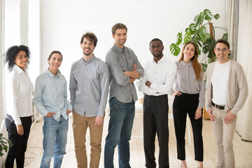 Young happy multiracial professionals or company staff looking at camera smiling, multi-ethnic...