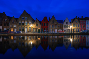Fototapeta na wymiar View of a canal and old historical buildings in Bruges, Belgium at dusk