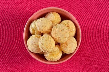 Cheese breads on pink texture background