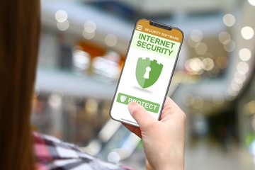 Internet security idea, girl with frameless phone on blurred mall background