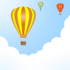 Flying color hot air balloons with hanging wicker basket with background weight with white and blue clouds 