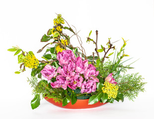 Decorative flower arrangement on the table on a white background.