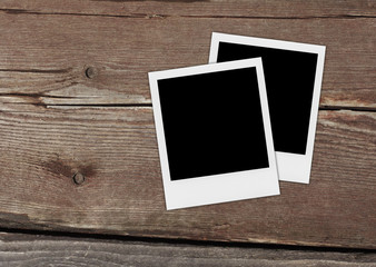 Retro realistic blank instant photo on wooden background.