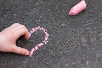 Schoolgirls hand shows heart gesture
