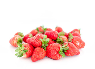 Scattered strawberries isolated on a white background. Weight loss diet or healthy eating.