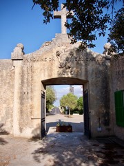 Historic church entrance surmounted by a cross at Santuari de Cura, Mallorca, Spain