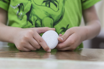 Obraz na płótnie Canvas Handmade - little boy painting stone . activity for children