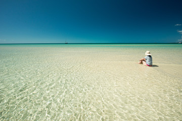 Fototapeta na wymiar Woman in the lagoon, Eleuthera Island, Bahamas