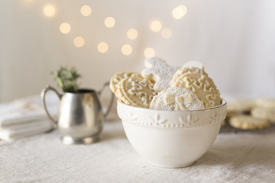 Close-up of gingerbread cookies on table against illuminated lights during Christmas
