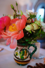 Dining table setting at Provence style, with candles, lavender, vintage crockery and cutlery, closeup. Beautiful wedding decoration with flowers pink violet purple white colors