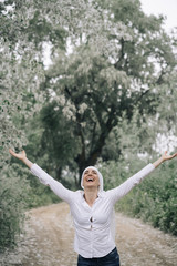 woman with white headscarf in the forest, has cancer