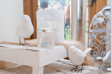 Dining table setting at Provence style, with candles, lavender, vintage crockery and cutlery, closeup. Beautiful wedding decoration with flowers pink violet purple white colors