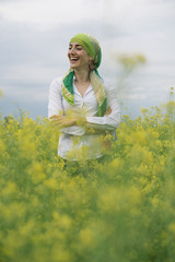 woman with colorful headscarf in the forest, has cancer