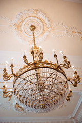 Luxurious white negotiation room in the office, with a large table and crystal chandelier, stock photo