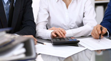 Bookkeepers team or financial inspectors  making report, calculating or checking balance. Tax service financial document. Audit concept