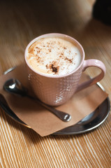 Morning coffee, Cappuccino coffee on wooden table. Beautiful foam, greenery ceramic cups, stylish toning, place for text.