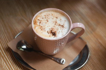 Morning coffee, Cappuccino coffee on wooden table. Beautiful foam, greenery ceramic cups, stylish toning, place for text.